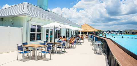people sitting at tables outside a building