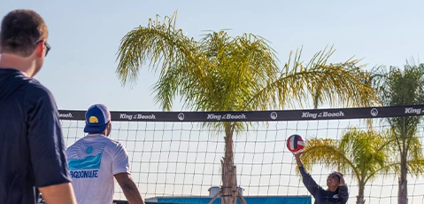 a couple of men playing volleyball