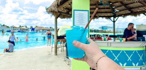 a hand holding a drink