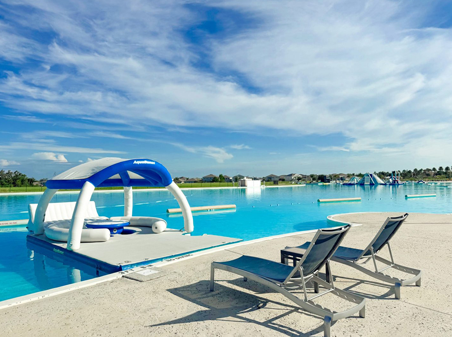 a pool with lounge chairs and a floating raft