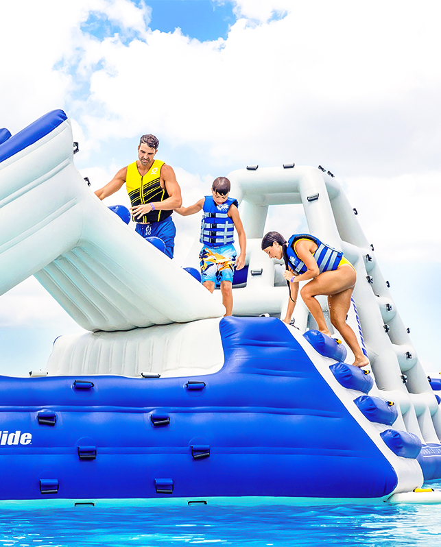 a group of people on an inflatable slide