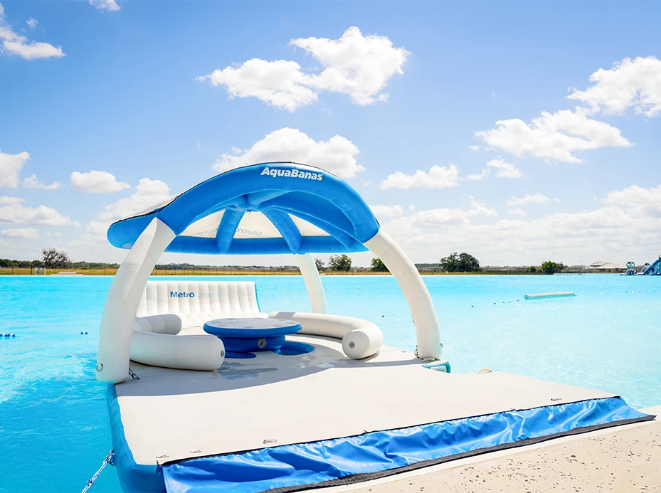 a floating raft with a table and chairs in the water