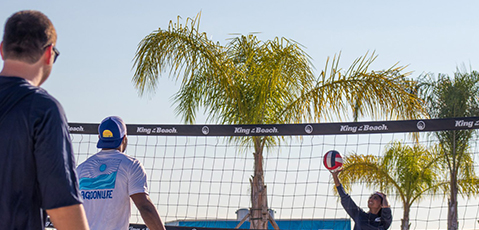 a couple of men playing volleyball