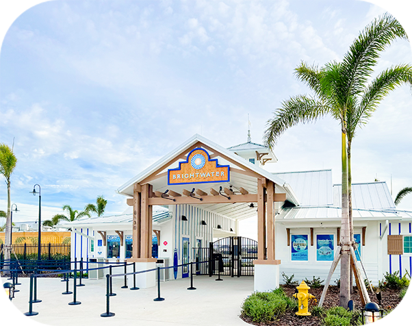 a building with a sign and palm trees