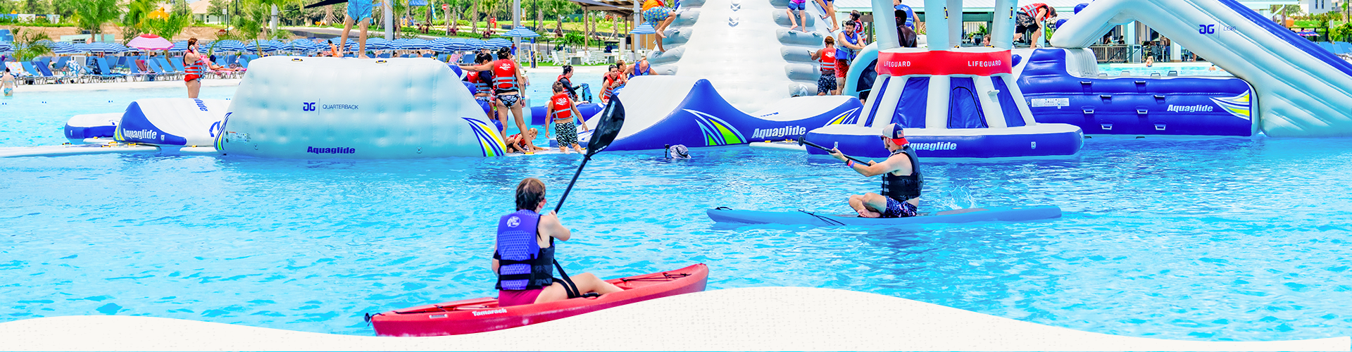 people in kayaks in a pool