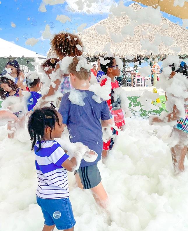 a group of people in a foamy area