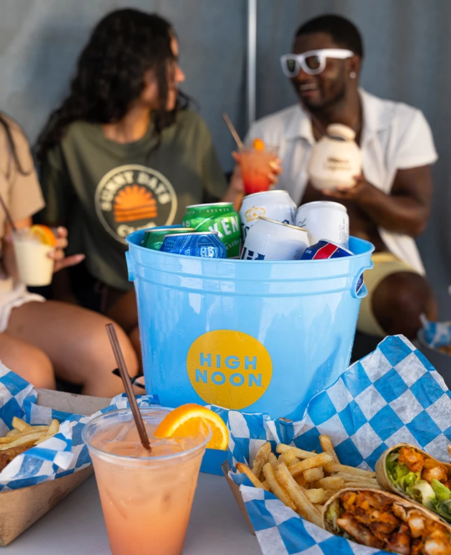 a group of people sitting around a table with food and drinks