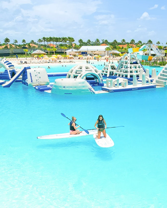 a couple of people on surfboards in a water park