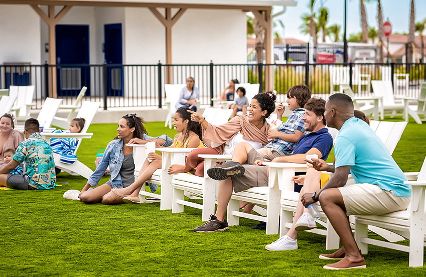 a group of people sitting on white benches