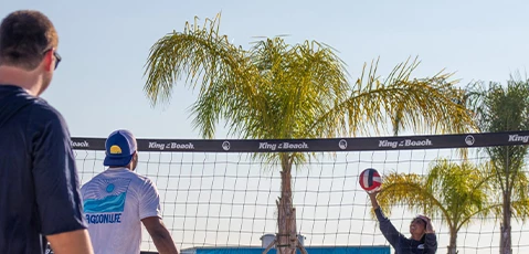 a couple of men playing volleyball
