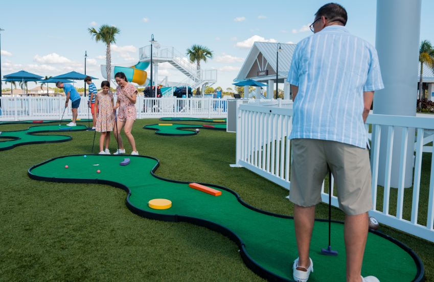 a group of people playing mini golf
