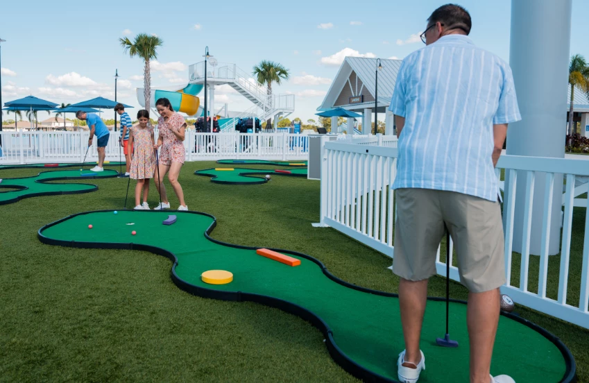 a group of people playing mini golf