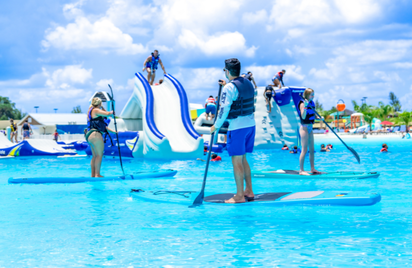 people on paddle boards in a pool