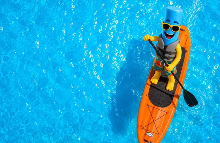 a toy figure on a paddle board in a pool