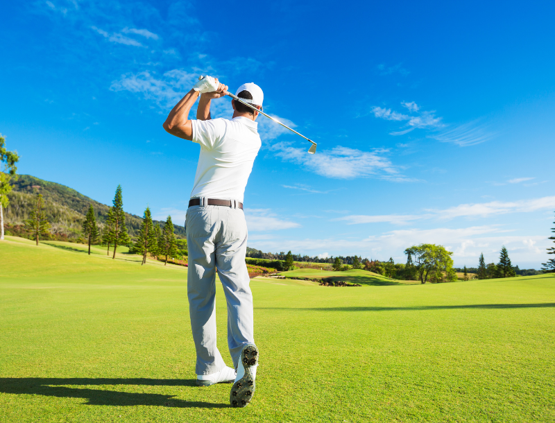 a man swinging a golf club