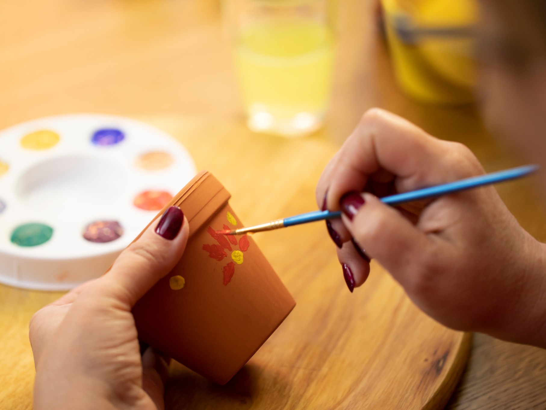 a person painting a pot