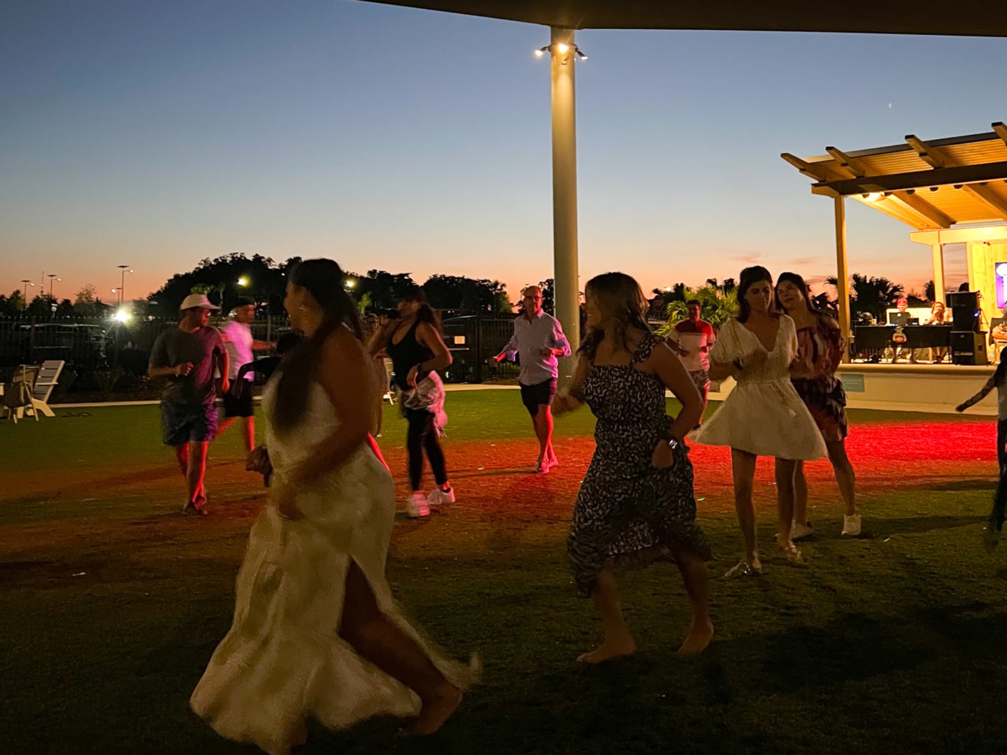 a group of people dancing on grass