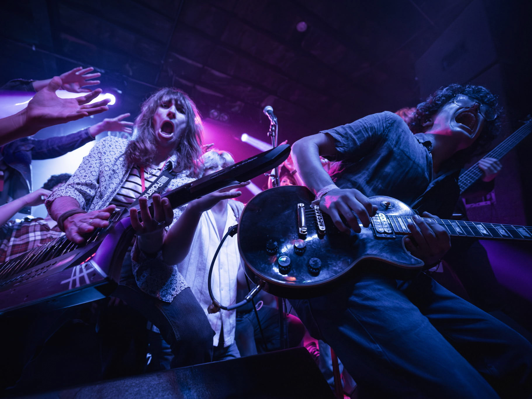 a group of people playing guitars and singing