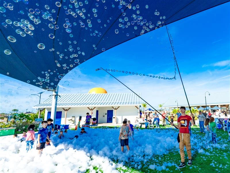 a group of kids playing with bubbles