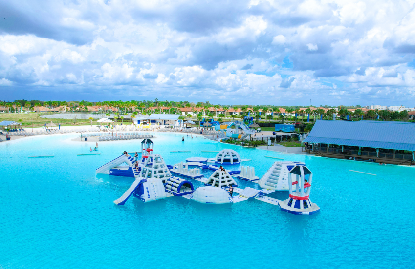 a water park with a water slide and people swimming