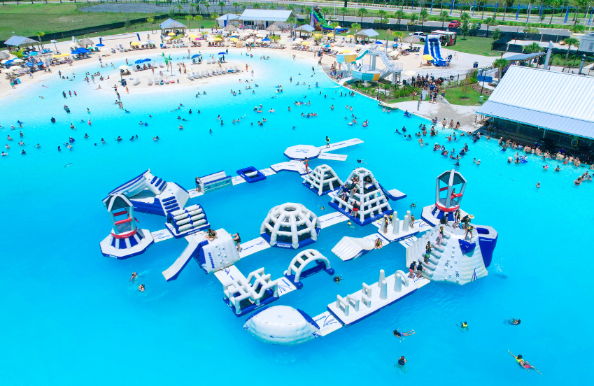 a large pool with water slides and people swimming