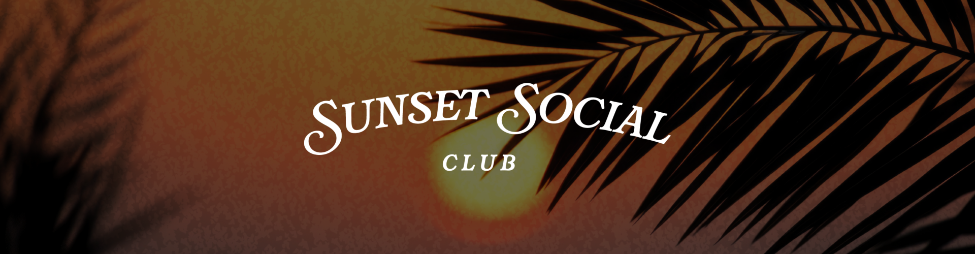 a palm leaf with a sun behind it