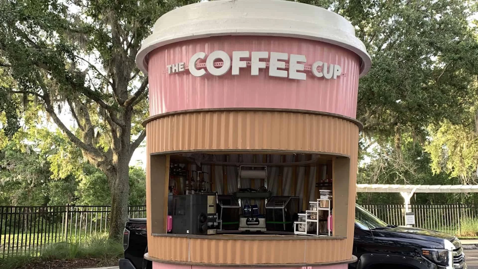 a coffee shop in a pink and white container