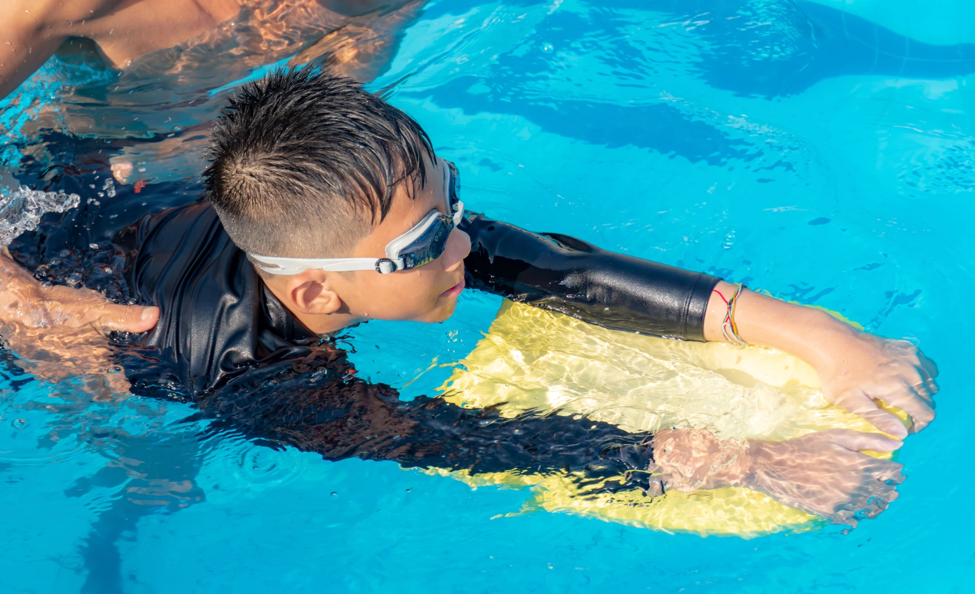 a boy in a swimming pool
