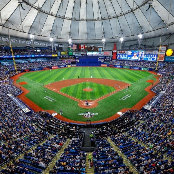 a baseball stadium with people in the stands with Tropicana Field in the background