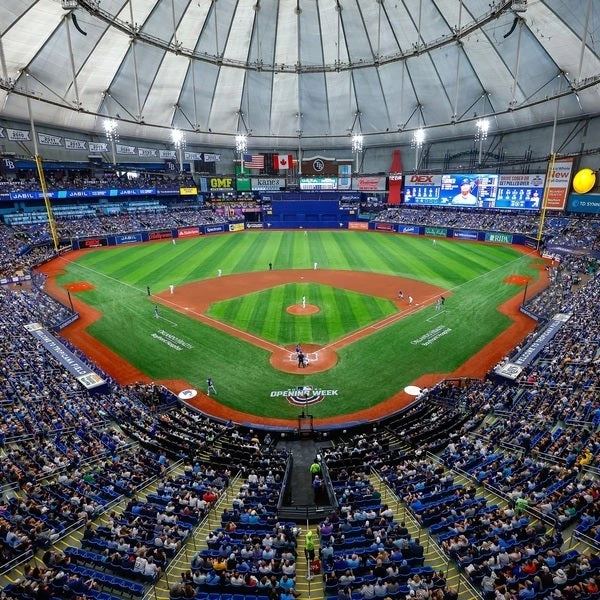 a baseball stadium with people in the stands with Tropicana Field in the background