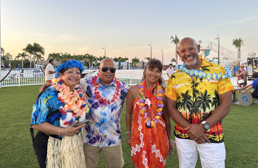 a group of people wearing leis and smiling