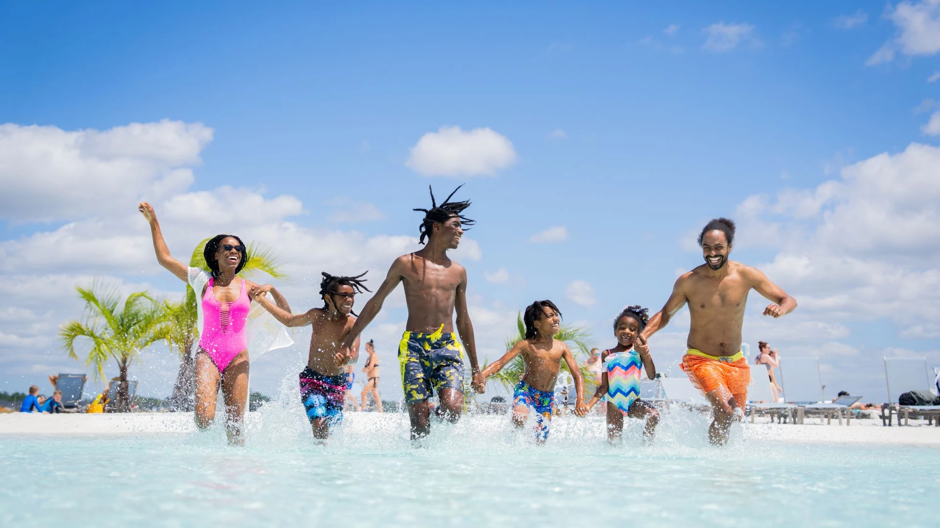 a group of people running in water