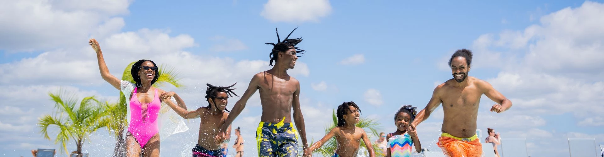 a group of people running in water