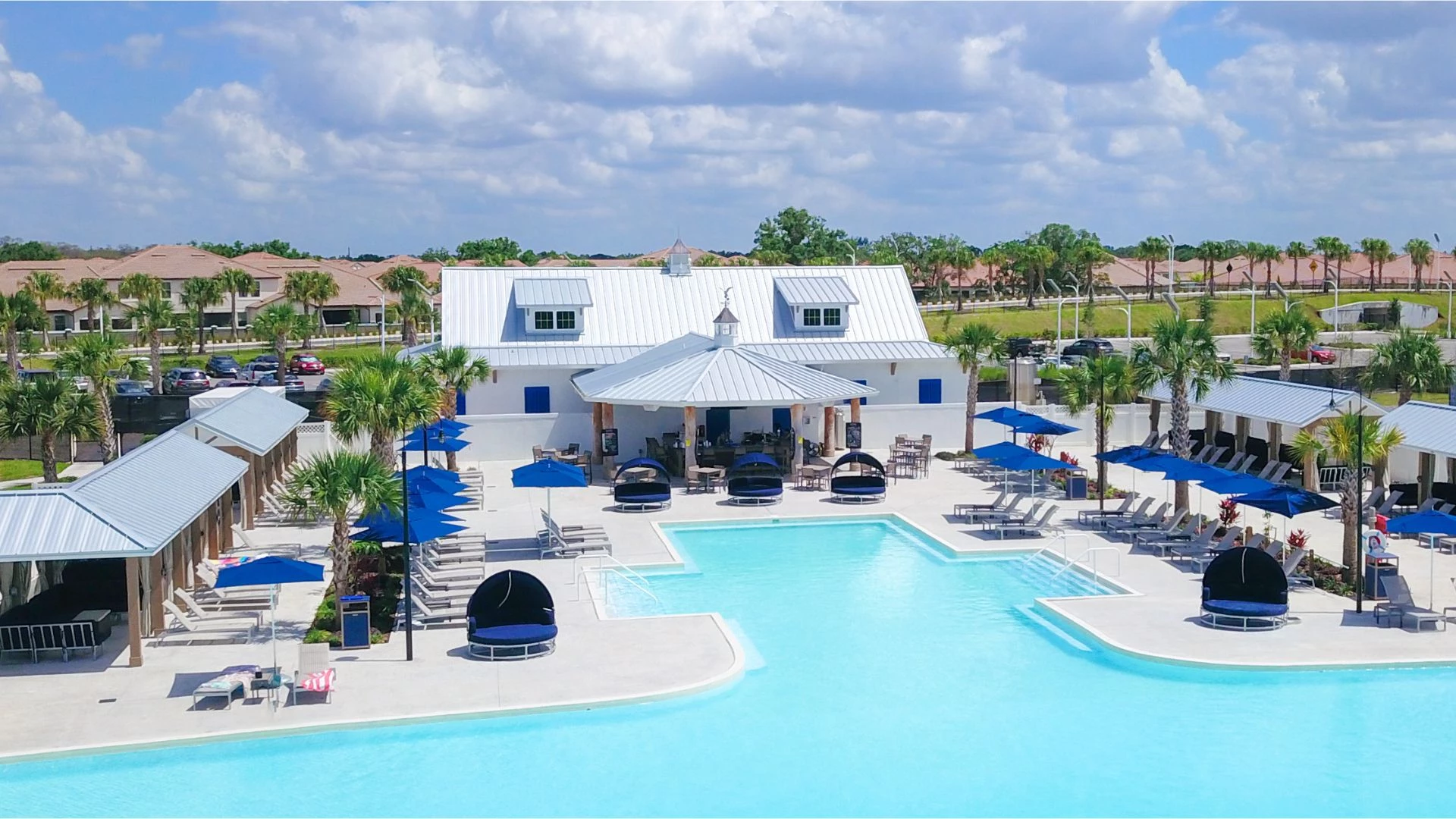 a swimming pool with chairs and umbrellas