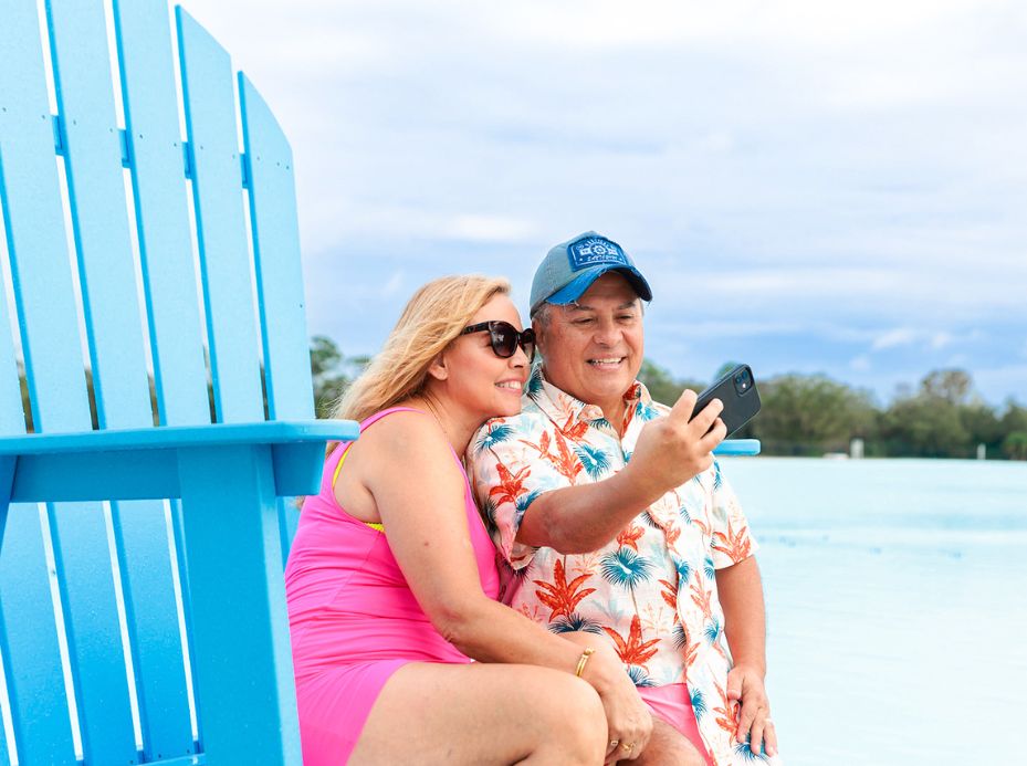 a man and woman sitting on a chair