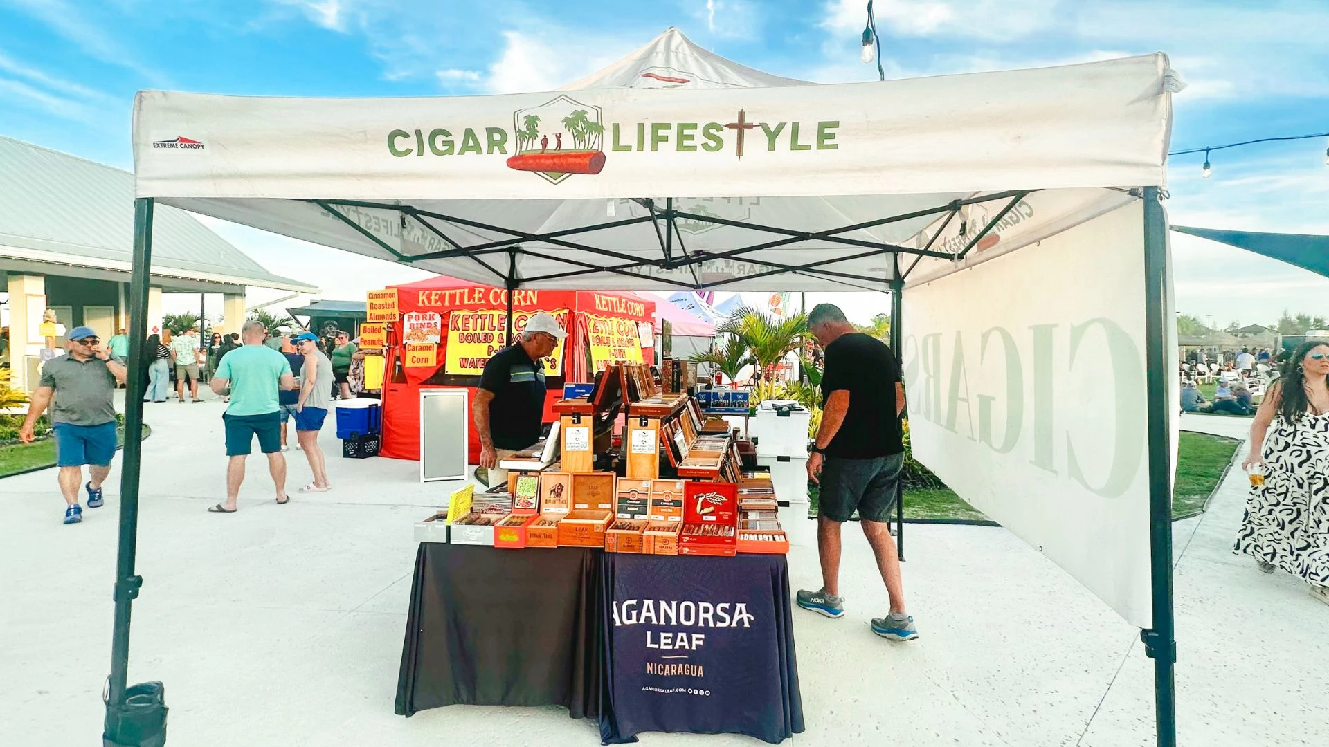 a man standing in front of a table with a sign