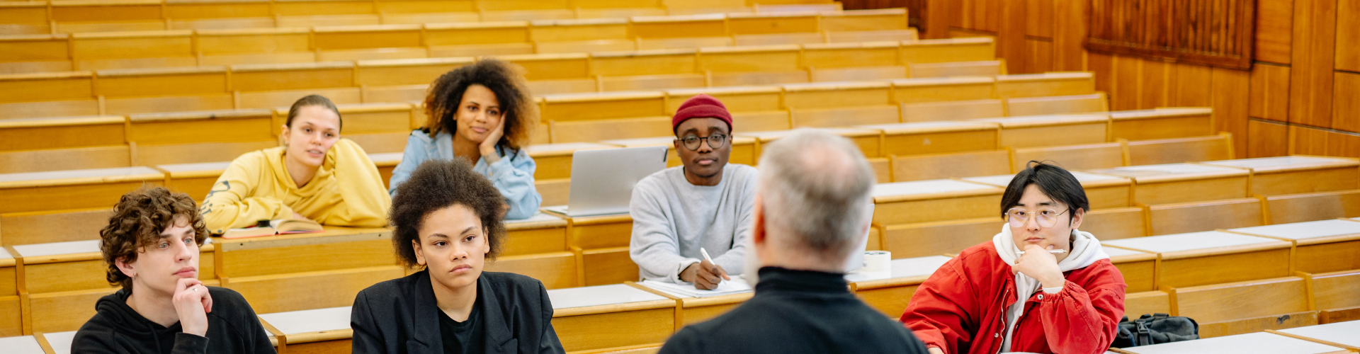 a group of people sitting in a lecture hall