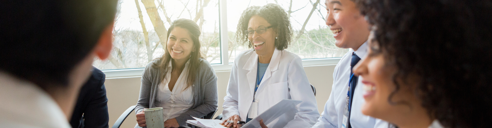a woman in a white coat laughing