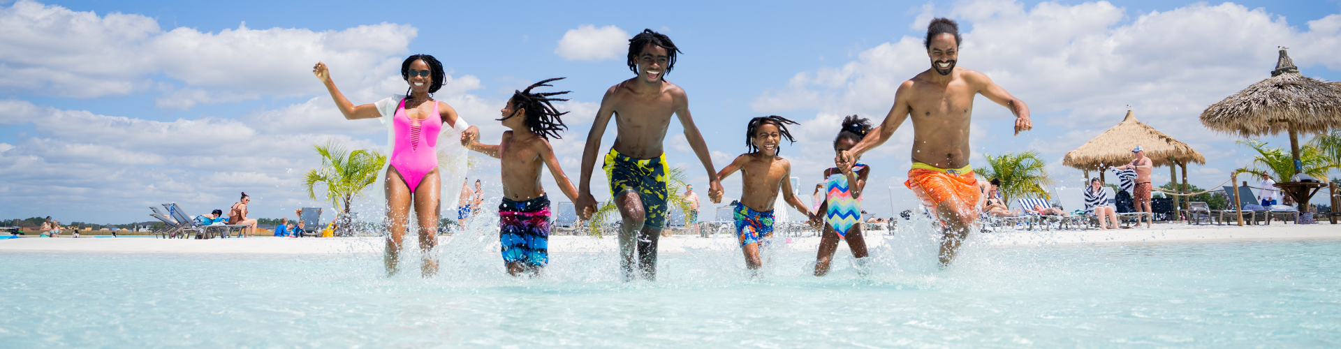 a group of people running in water