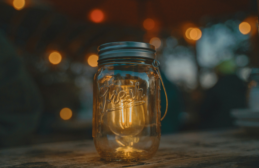 a glass jar with a light bulb inside