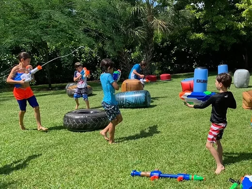 a group of kids playing with water guns