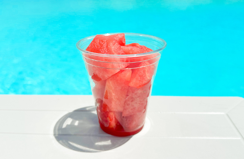a plastic cup with watermelon slices in it