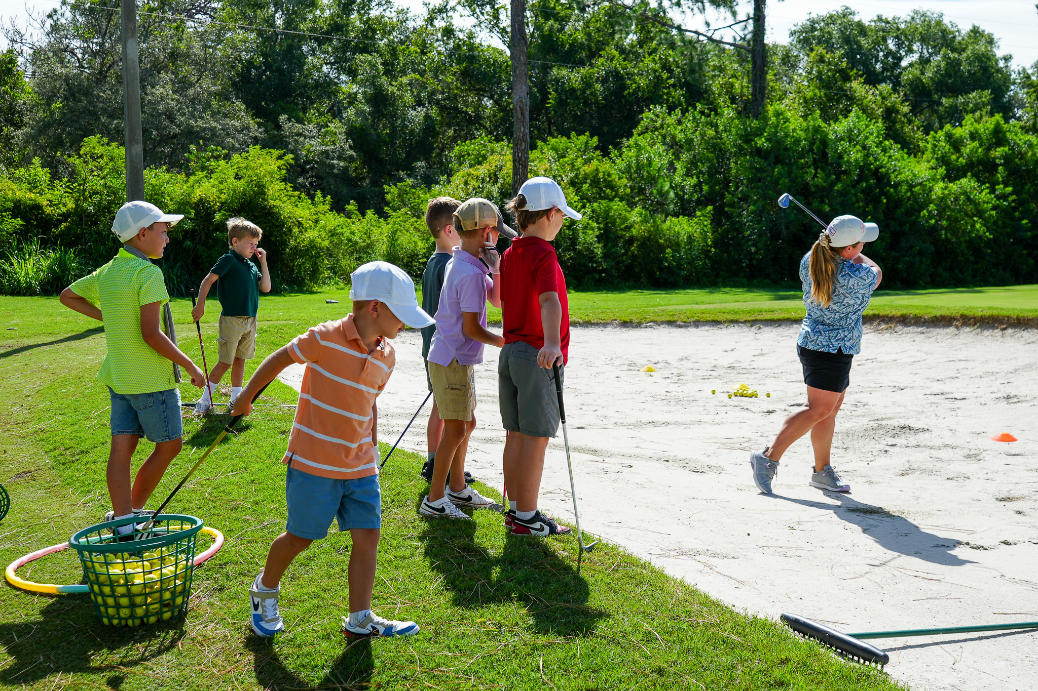 a group of kids playing golf
