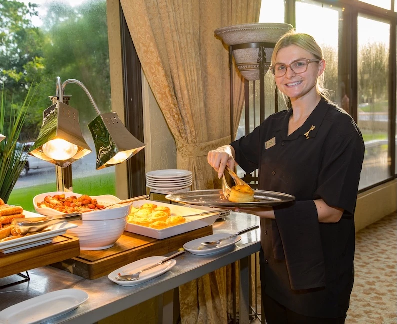 a woman holding a tray of food