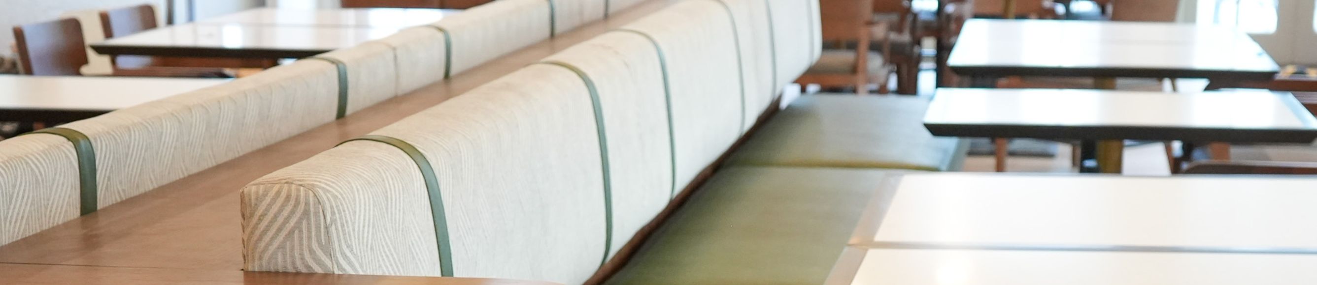 a white restaurant booth with green strips 