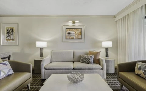 a room with a couch and two chairs