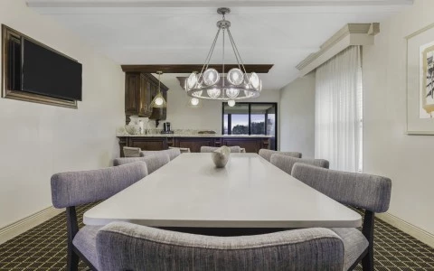 a dining table with chairs and a chandelier
