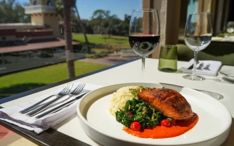 a plate of food and wine glasses on a table