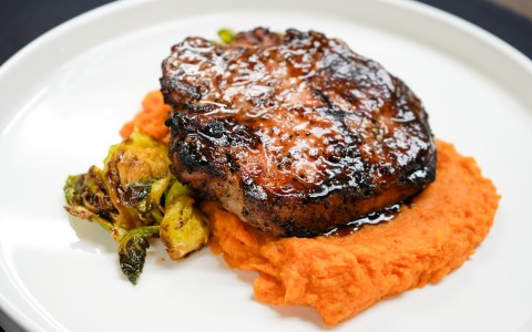 a plate of food on a black surface