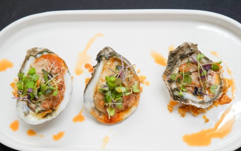 a plate of food on a black surface